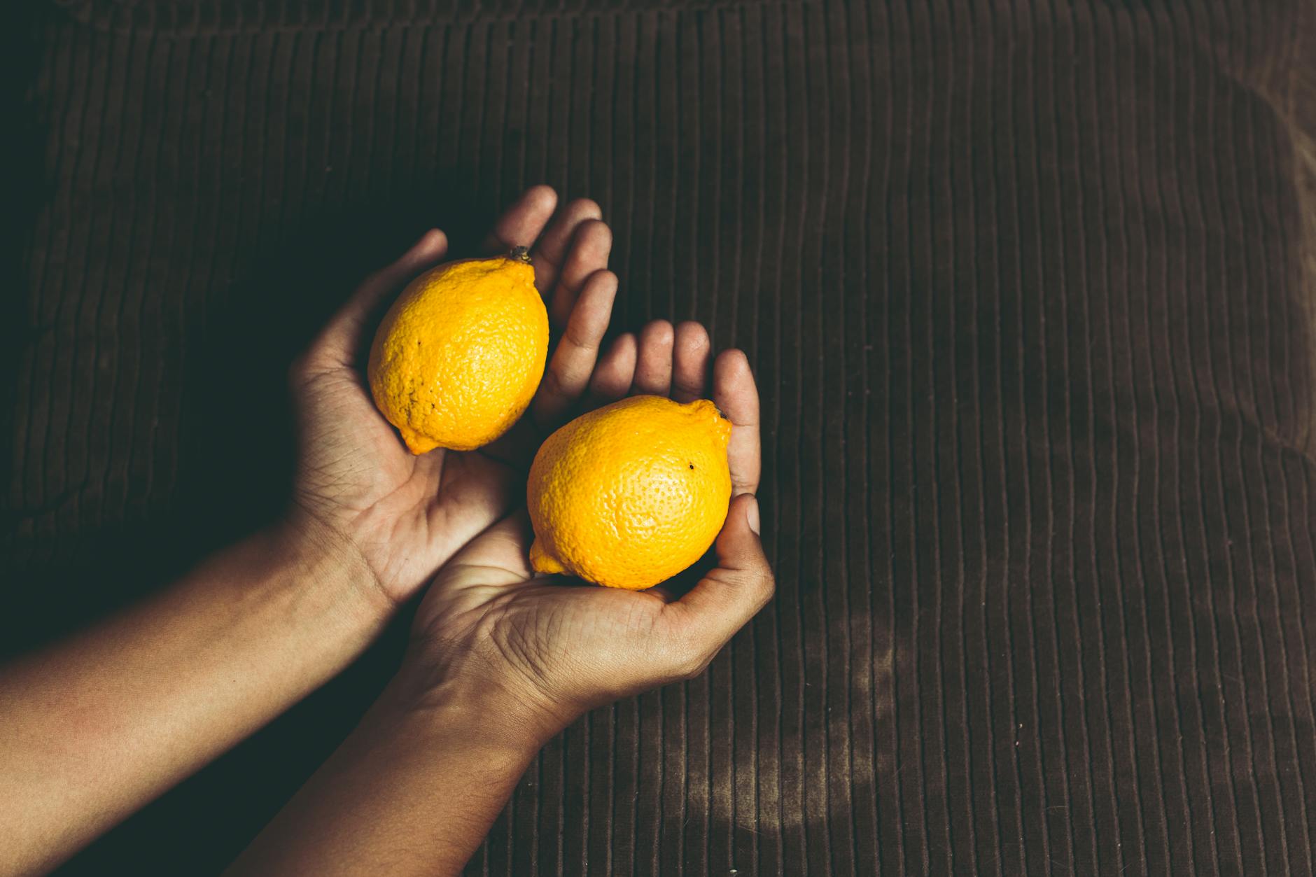 Bright yellow lemons on a sunny yellow background, representing freshness and renewal during separation